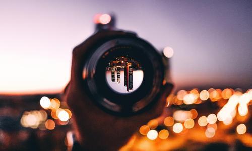 city unside down through a pipe