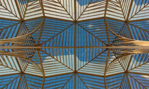 gold metal glass roof structure blue white